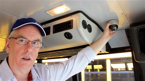 Installer shows placement of camera in bus 